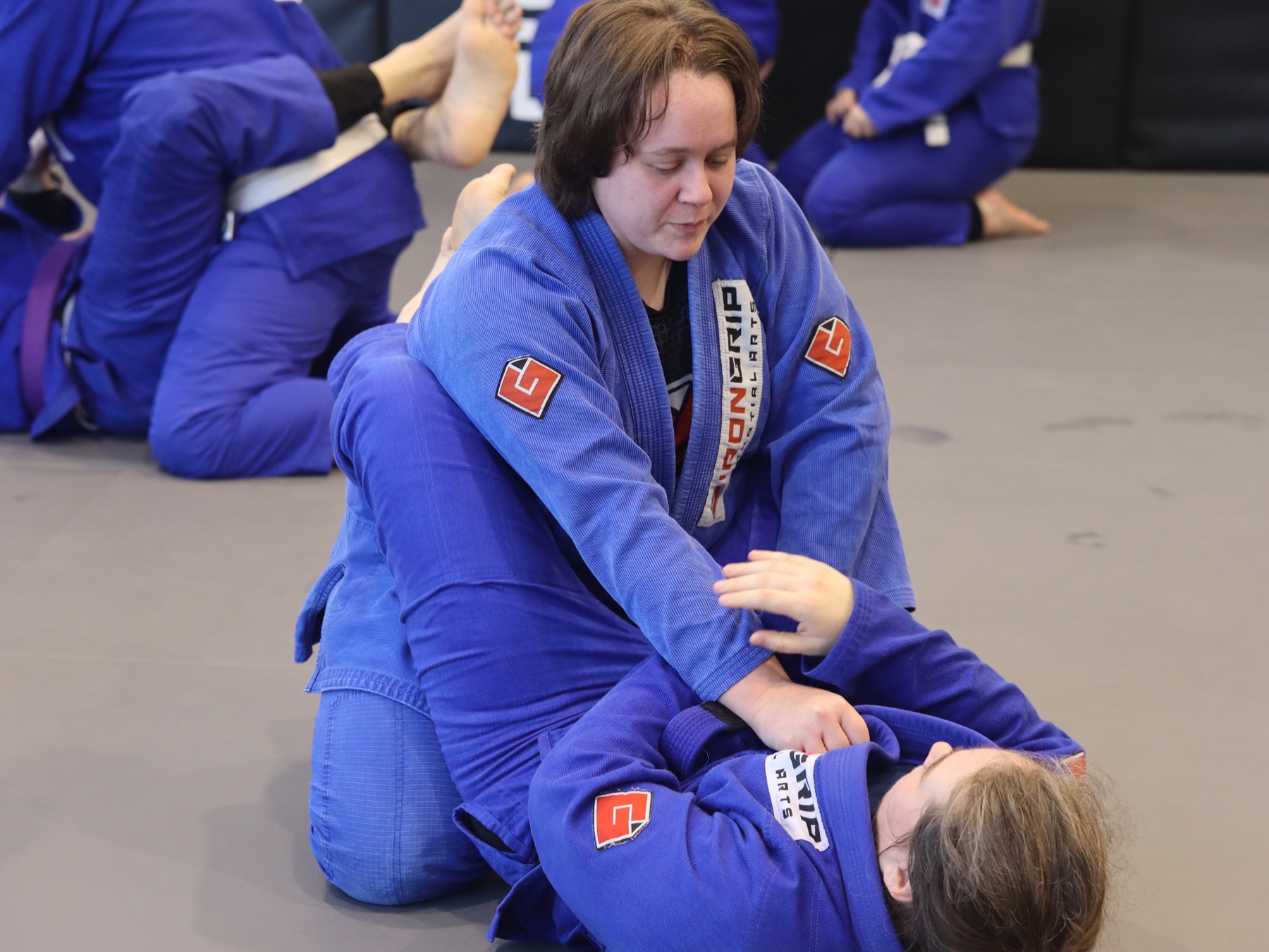 Irna Oosthuizen helping a training partner practise a movement on the mat