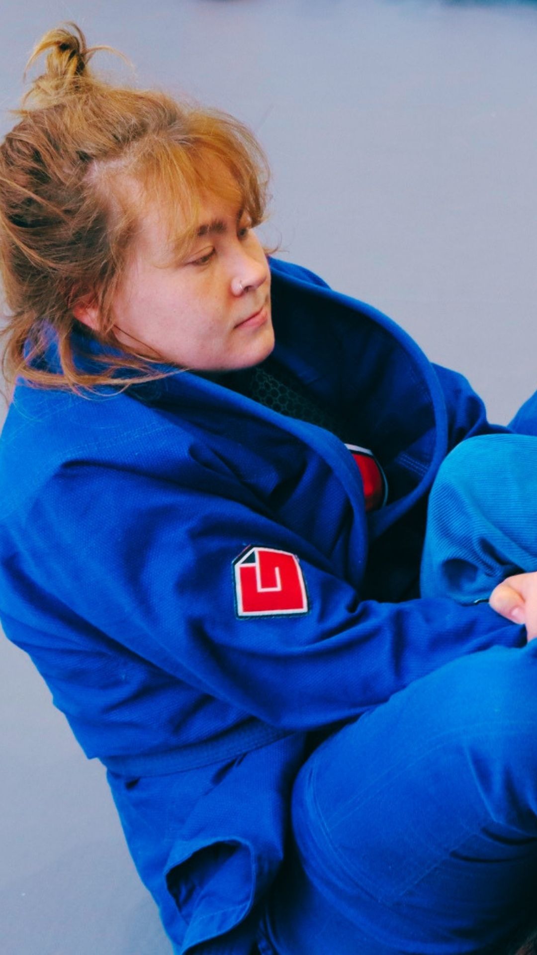 Larissa Van Der Westhuizen training in her blue martial arts uniform at Iron Grip