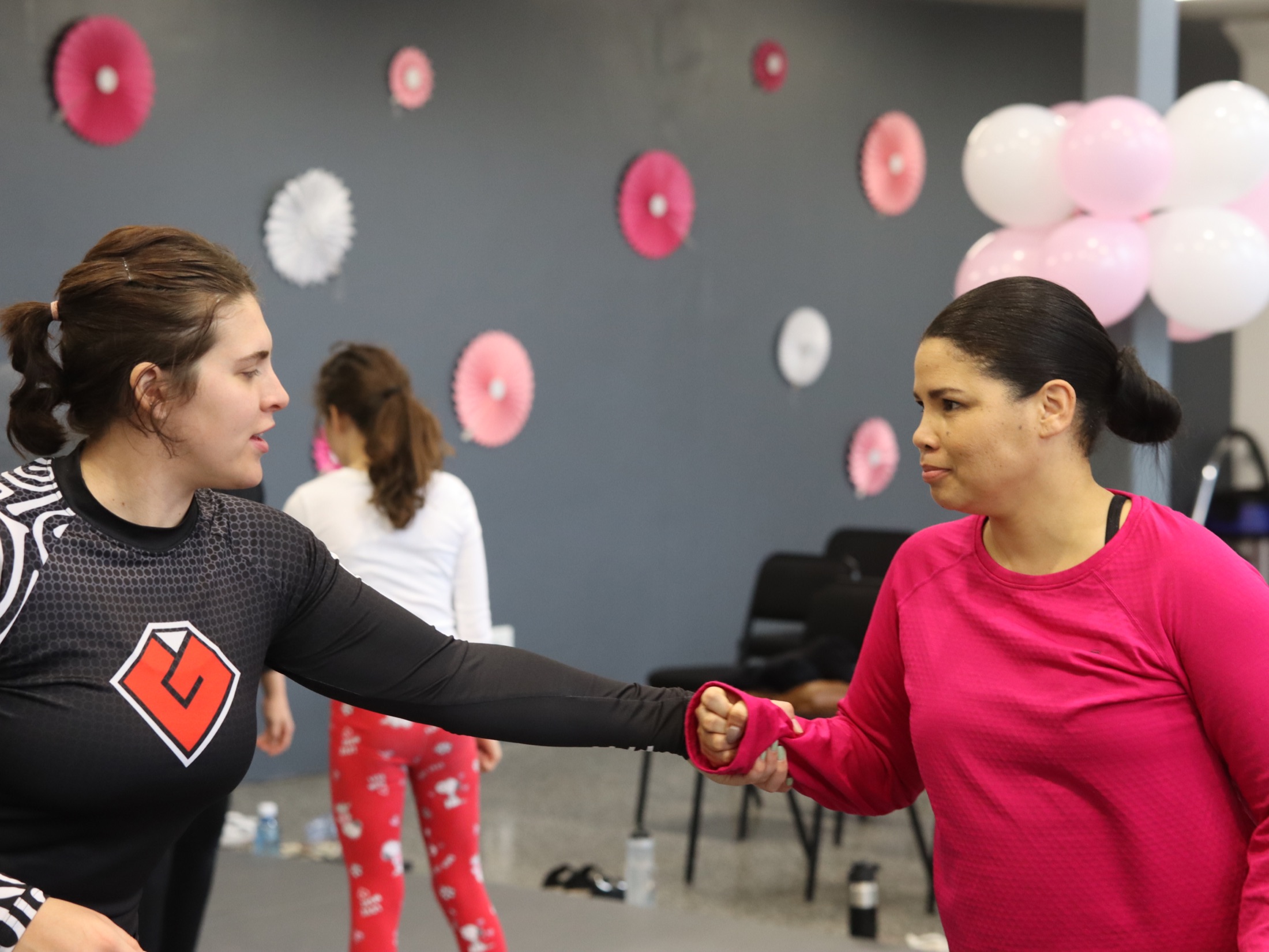 An Iron Grip coach guides a participant through a practical hand-release movement